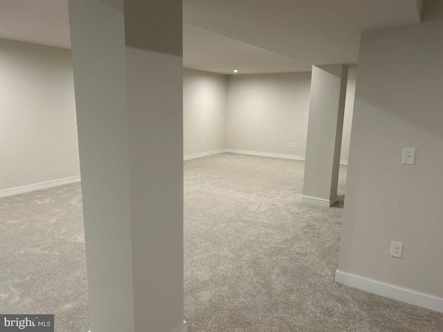 basement featuring light colored carpet