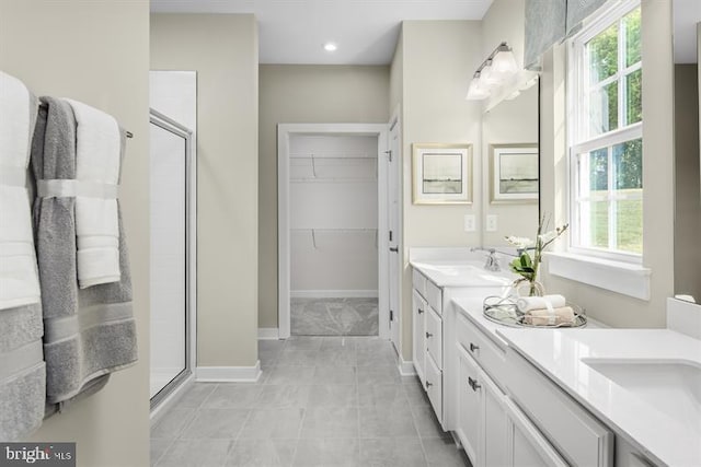 bathroom featuring an enclosed shower and vanity