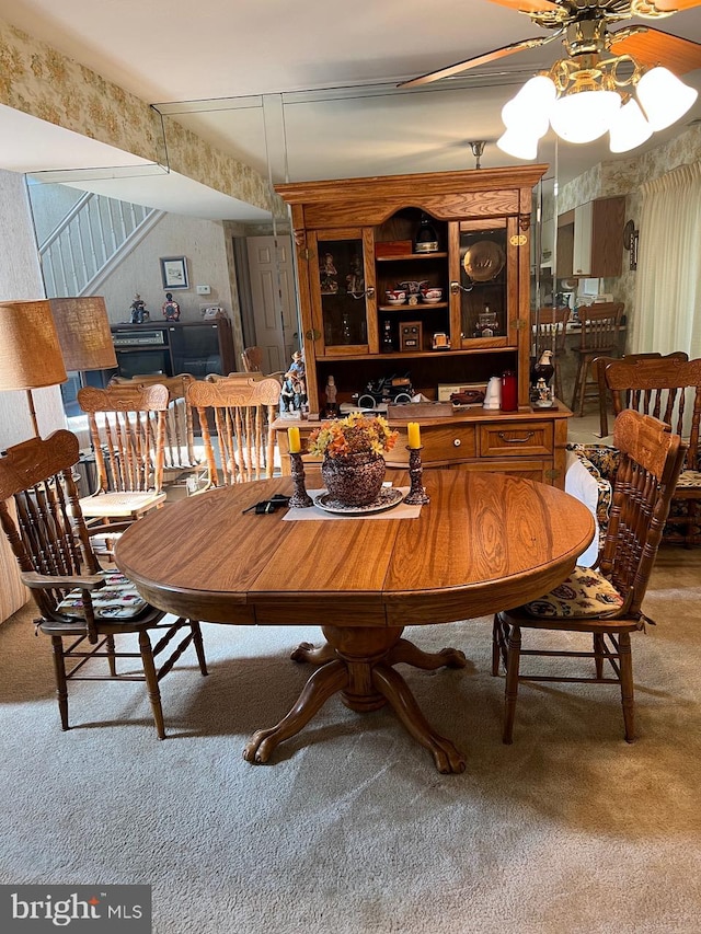 carpeted dining area featuring ceiling fan