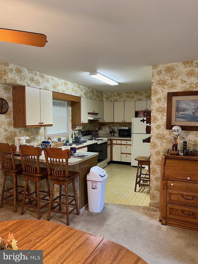 kitchen with backsplash, white cabinetry, white appliances, and light tile floors