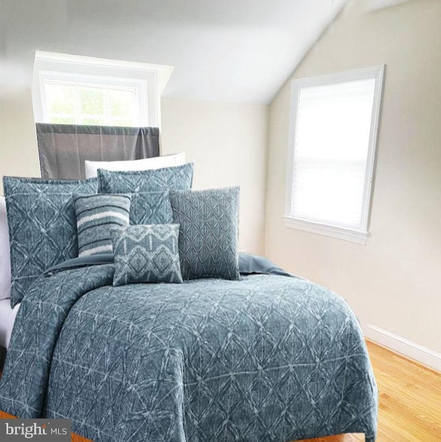 bedroom with hardwood / wood-style flooring and vaulted ceiling