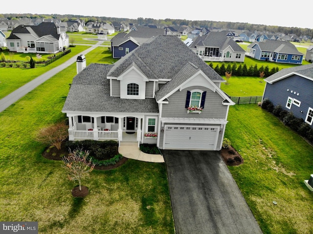 view of front facade with a porch, a garage, and a front yard