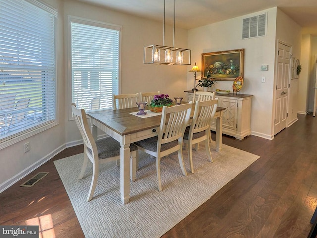 dining space with dark hardwood / wood-style floors