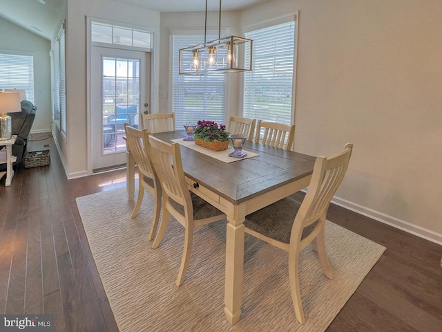 dining area with a chandelier and dark hardwood / wood-style floors