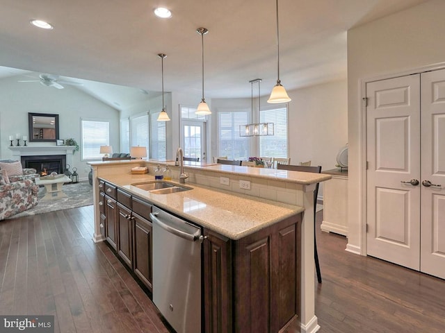 kitchen featuring dark wood-type flooring, sink, stainless steel dishwasher, dark brown cabinetry, and lofted ceiling