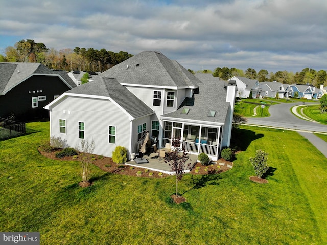 back of house featuring a lawn