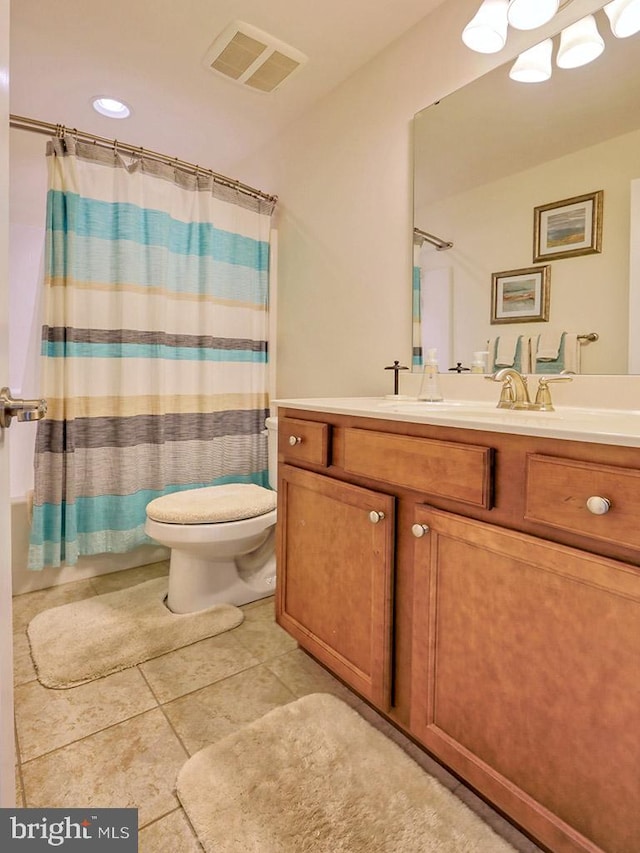 bathroom with vanity, toilet, and tile floors