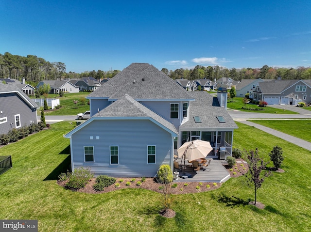 rear view of property with a yard and a garage