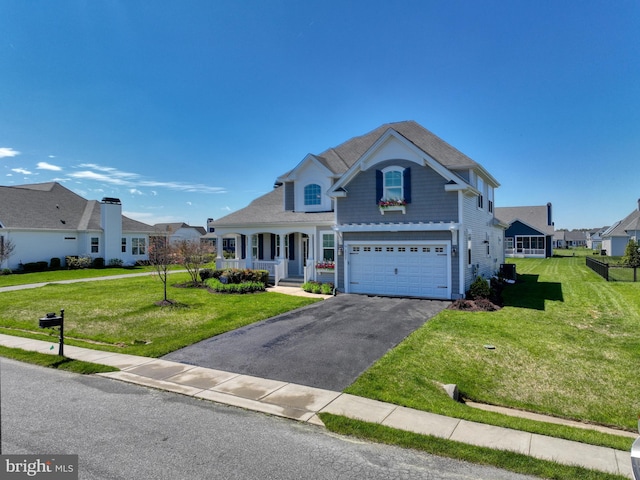 view of front of house with a front yard and a garage