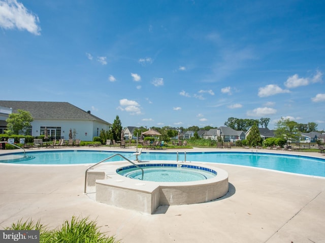 view of swimming pool with a community hot tub