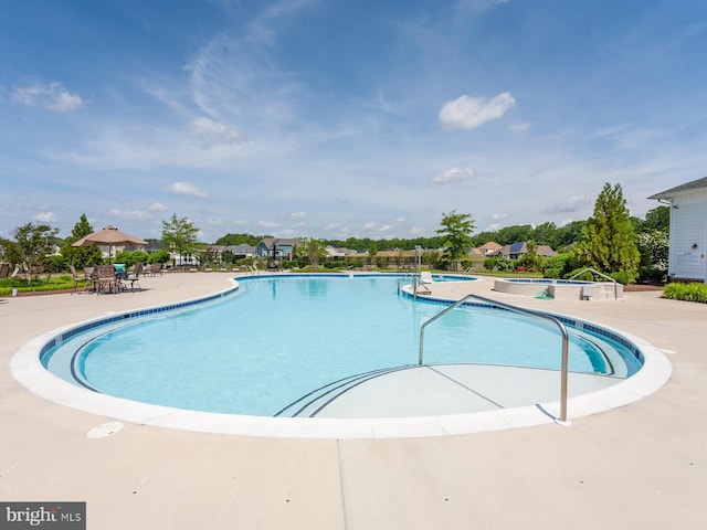 view of swimming pool with a patio