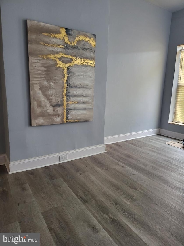 spare room featuring dark wood-type flooring