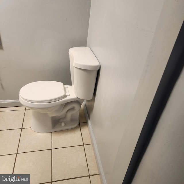 bathroom featuring tile flooring and toilet