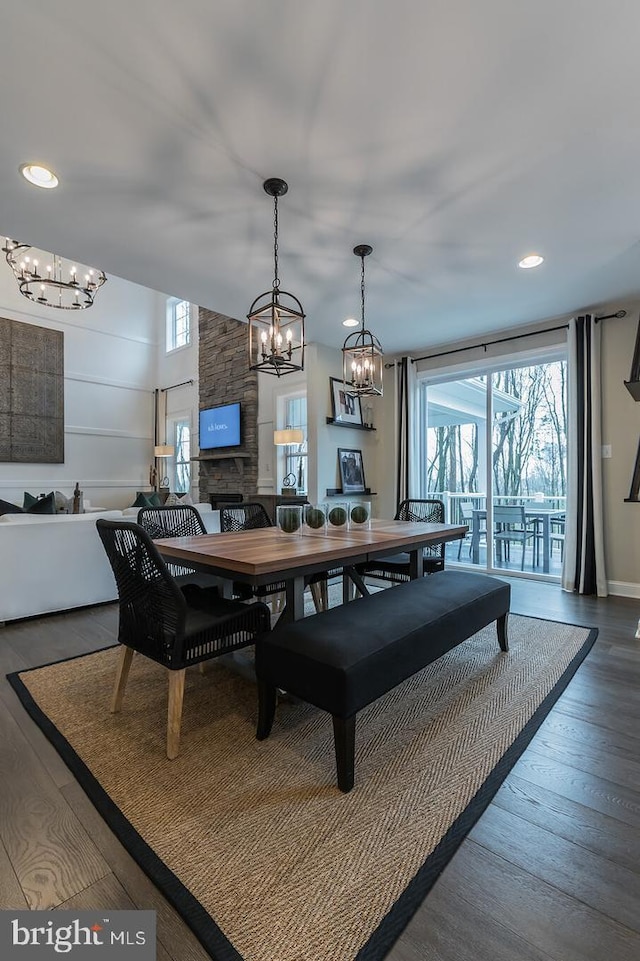 dining space with dark wood-type flooring and a chandelier