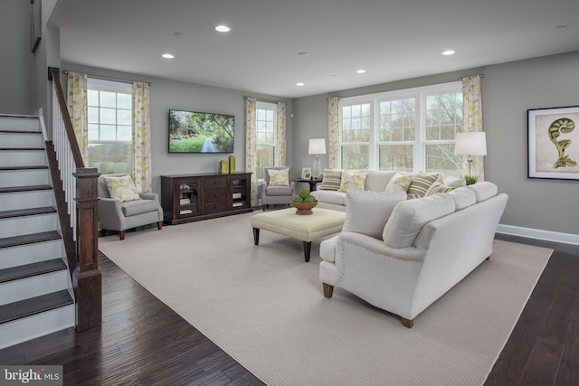 living room featuring a wealth of natural light and dark hardwood / wood-style floors