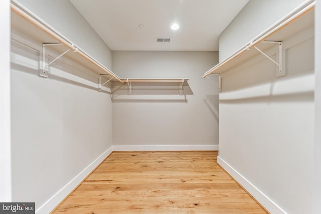 spacious closet featuring hardwood / wood-style flooring