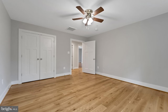 unfurnished bedroom featuring a closet, ceiling fan, and light hardwood / wood-style flooring