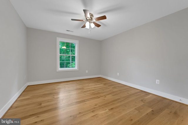 empty room with ceiling fan and light hardwood / wood-style floors