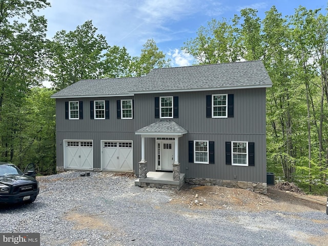 view of front facade featuring central AC unit and a garage