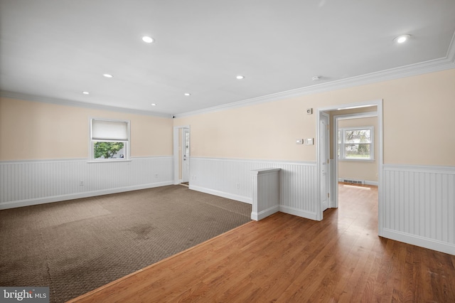 spare room featuring ornamental molding and dark hardwood / wood-style floors