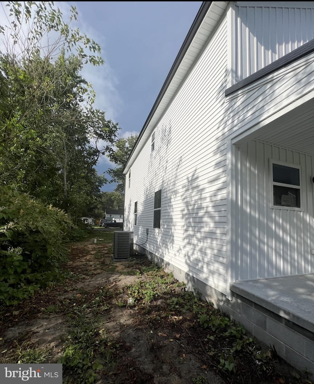 view of side of home featuring cooling unit