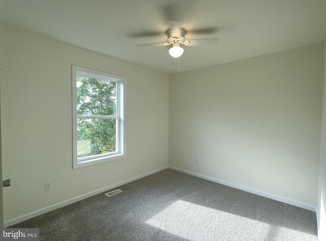 spare room featuring carpet flooring and ceiling fan