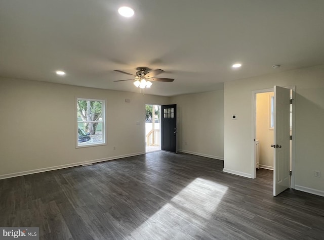 empty room featuring dark wood-type flooring and ceiling fan