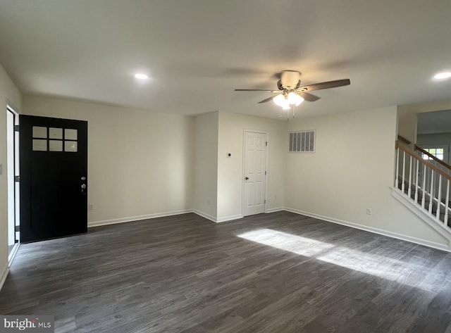 unfurnished room featuring dark wood-type flooring and ceiling fan