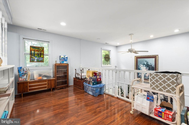 playroom featuring wood-type flooring, ceiling fan, and a healthy amount of sunlight