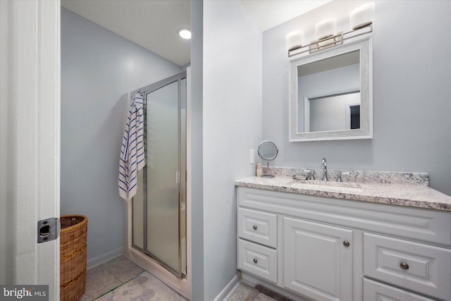 bathroom featuring an enclosed shower, tile floors, and vanity