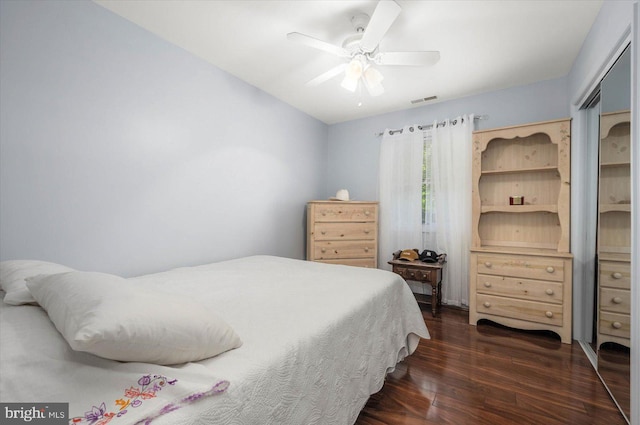 bedroom featuring ceiling fan and dark hardwood / wood-style floors