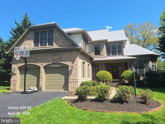 view of front of property featuring a garage and a front lawn