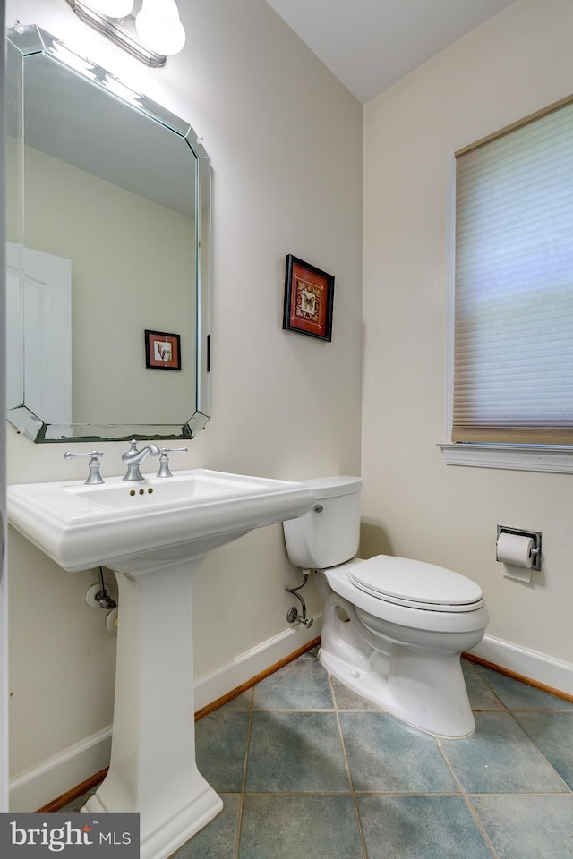 bathroom with tile floors and toilet