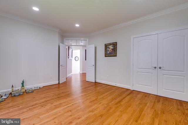 foyer with light hardwood / wood-style floors and crown molding