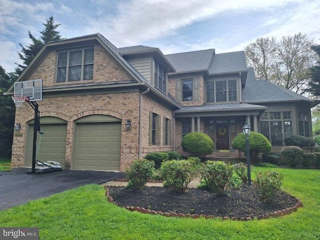 view of front of home with a garage and a front lawn