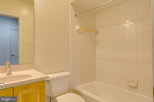 full bathroom with tiled shower / bath combo, toilet, and vanity