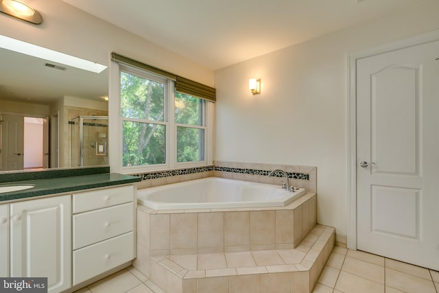 bathroom with separate shower and tub, vanity, and tile floors