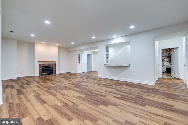 unfurnished living room featuring light hardwood / wood-style floors and a fireplace