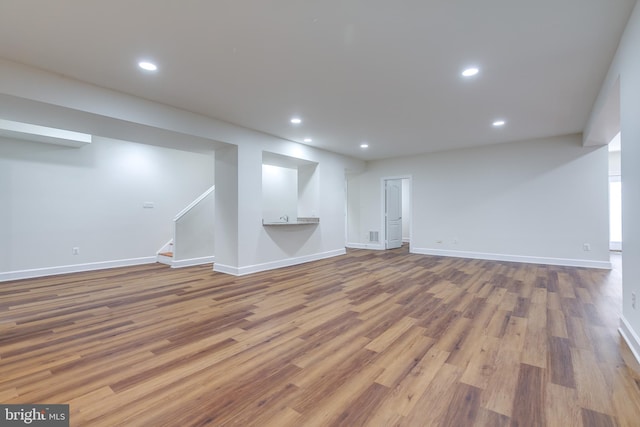 basement featuring hardwood / wood-style floors