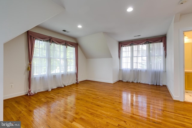 bonus room featuring vaulted ceiling and light hardwood / wood-style flooring