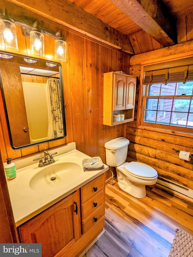 bathroom featuring wood walls, beam ceiling, vanity, and hardwood / wood-style flooring