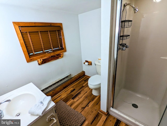 bathroom featuring walk in shower, a baseboard radiator, vanity, hardwood / wood-style floors, and toilet