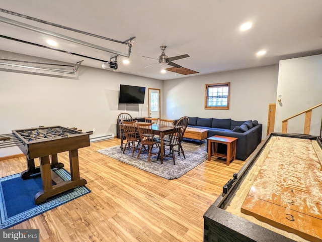 dining room featuring light hardwood / wood-style flooring, ceiling fan, and a baseboard radiator