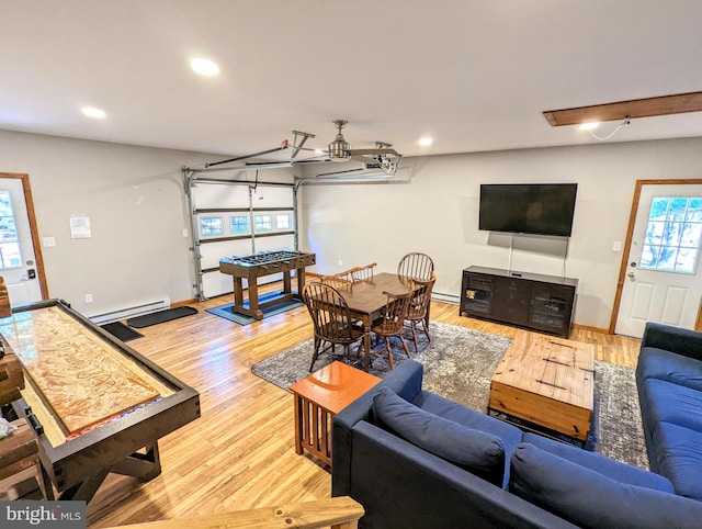 living room featuring light wood-type flooring and baseboard heating