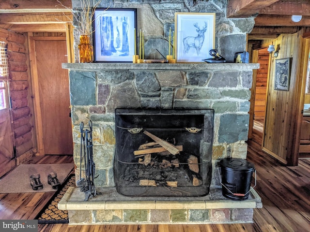 room details featuring a stone fireplace and hardwood / wood-style floors