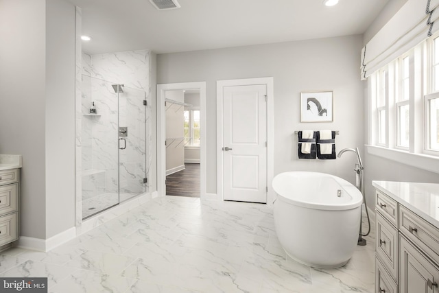 bathroom featuring shower with separate bathtub, tile floors, and vanity