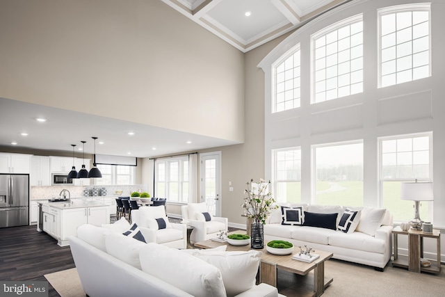 living room with sink, plenty of natural light, hardwood / wood-style floors, and coffered ceiling