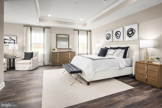 bedroom with dark wood-type flooring and a raised ceiling