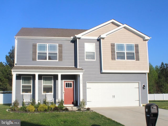 view of front of house with a front yard and a garage