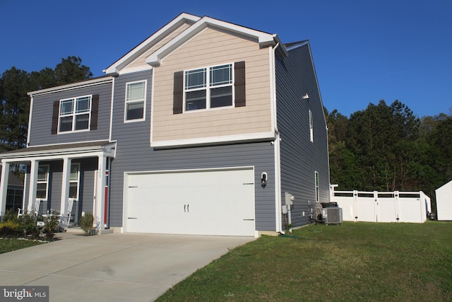 view of front of home with a front yard, a garage, and central air condition unit